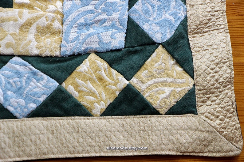 Quilted table mat in yellow and blue floral velvet for children.