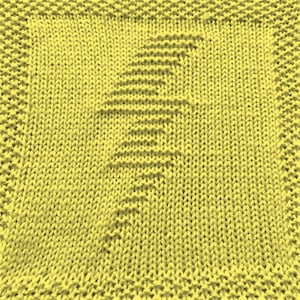 May include: A yellow knitted dishcloth with a simple design.