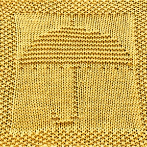 May include: A yellow knitted dishcloth with a cross pattern.