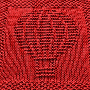 May include: Red knitted dishcloth with a heart design.