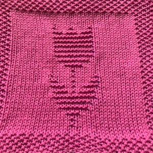 May include: A pink knitted dishcloth with a textured design. The dishcloth is made of cotton yarn and is perfect for cleaning dishes and drying hands.