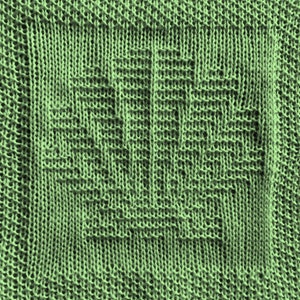 May include: A close-up of a green knitted fabric with a textured pattern. The fabric has a soft, fuzzy texture.