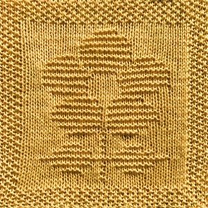 May include: A yellow knitted dishcloth with a woven pattern in the centre.
