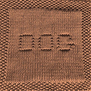 May include: A brown knitted dishcloth with the word "HOPE" knitted into the fabric.