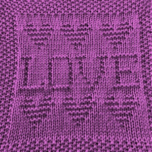 May include: Purple knitted dishcloth with the word "LIFE" woven into the fabric.