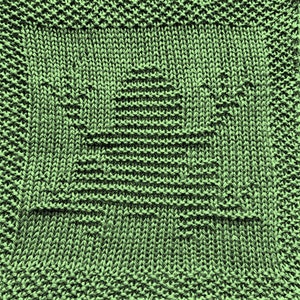 May include: A green knitted dishcloth with a star pattern.