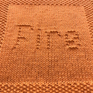 May include: A close-up of a knitted orange dishcloth with a textured pattern.