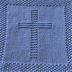 May include: A blue knitted dishcloth with a cross design.