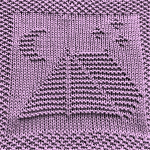 May include: A close-up of a purple knitted dishcloth with a textured pattern.