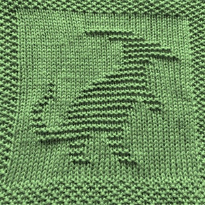 May include: A green knitted dishcloth with a geometric pattern. The pattern is created by using different knitting stitches to create a raised design.