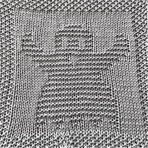 May include: Close-up of a knitted blanket in shades of gray. The blanket features a central design of a stylized tree, surrounded by a textured border. The knit pattern is visible, showcasing the detailed craftsmanship of the textile.