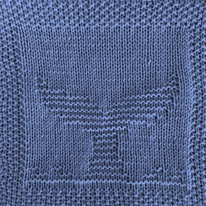 May include: A blue knitted fabric with a geometric pattern. The fabric is made of a soft, textured yarn.
