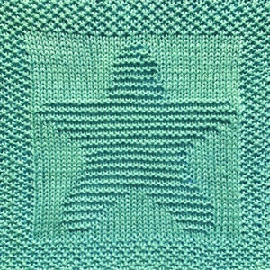 May include: A teal blue knitted dishcloth with a star design in the center.
