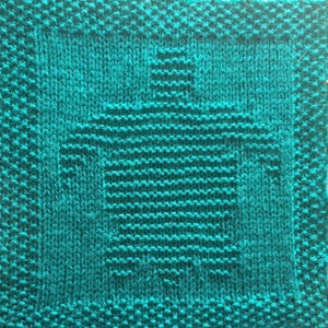 May include: A teal blue knitted dishcloth with a woven pattern in the center.