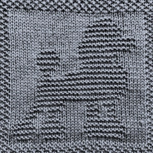 May include: A close-up of a grey knitted fabric with a textured pattern. The fabric is made of a soft, comfortable material and has a subtle sheen.