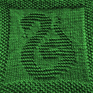 May include: A close-up of a green knitted fabric with a textured pattern.