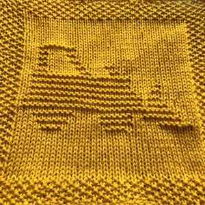 Puede incluir: Un paño de cocina de punto amarillo con un patrón geométrico simple.