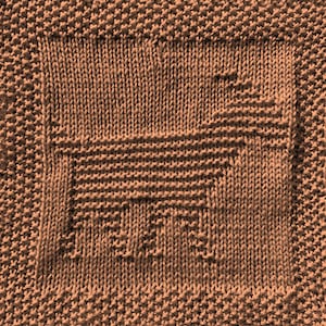 May include: A brown knitted dishcloth with a square design in the center.