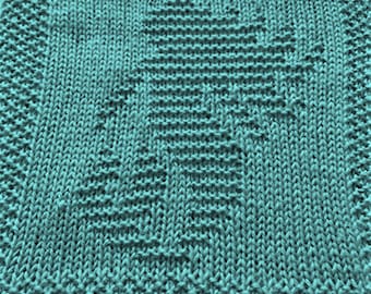 May include: A teal blue knitted dishcloth with a textured pattern.