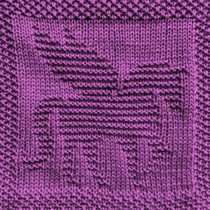 May include: A close-up of a purple knitted fabric with a textured pattern.
