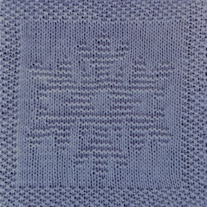 May include: A blue knitted dishcloth with a snowflake pattern.