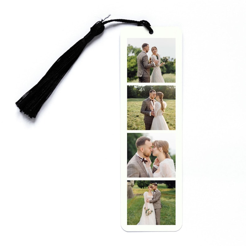 May include: A rectangular white bookmark featuring four stacked photographic prints of a couple in a field, accompanied by a black tassel attached to the top through a small hole. The images show the couple in various poses outdoors.