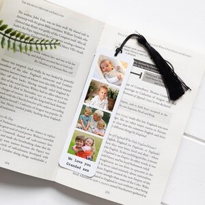 May include: A bookmark with four family photos and a black tassel, placed in a book. The bookmark has the text "We love you Grandad xxx" at the bottom. The book is open to page 104.