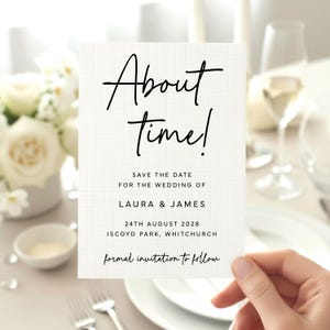 May include: A white rectangular save the date card with a subtle grid texture. The text reads About time! Save the date for the wedding of Laura & James, 24th August 2028, Iscoyd Park, Whitchurch, formal invitation to follow in black ink.