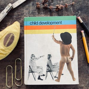Puede incluir: Un libro vintage titulado "child development" con un diseño de rayas coloridas. La portada presenta un collage de figuras. Una bolsa amarilla con forma de plátano, clips, una regla y lápices también están sobre la superficie de madera.
