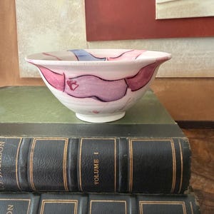 May include: A set of three ceramic mugs with a speckled, matte finish. The mugs are in shades of cream, light gray, and dark gray. Each mug has a simple, minimalist design and a rounded handle.