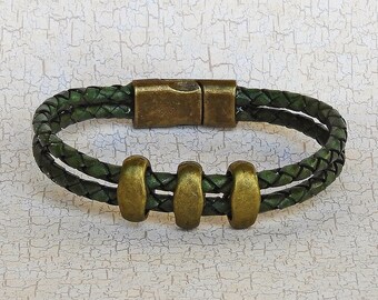 May include: A green leather bracelet with a magnetic clasp and four gold-toned metal beads.