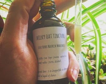 May include: A brown glass bottle with a white label that reads "MILKY OAT TINCTURE LOVE HERBS NOURISH WHOLENESS Milky Oat Tops (Avena sativa) in proof vodka (50% alcohol). Suggested dose: 1-8 dropperfuls as often as needed in liquid of choice."