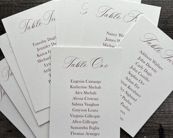 Tarjetas impresas para la distribución de asientos en bodas o eventos, en papel texturizado con bordes irregulares o rectos.