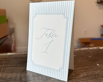 Blue tent-fold printed table numbers for weddings and events