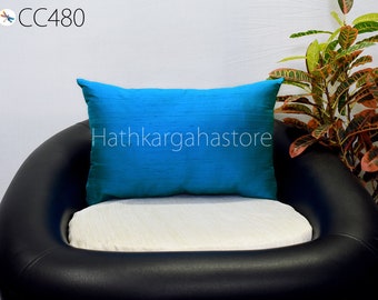 May include: A bright blue throw pillow with the text "Hathkarghastore" on a black leather chair with a white cushion.