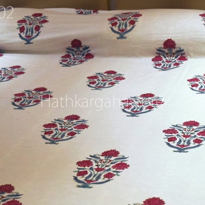 May include: White cotton bedding with a repeating floral pattern in shades of pink and blue. The pattern is a traditional Indian design. The text "DC02" is visible in the top left corner of the image.