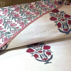 May include: White cotton pillowcase with a pink and green floral print. The pillowcase has a red and white striped border. The text "DC02" is visible in the top left corner of the image.
