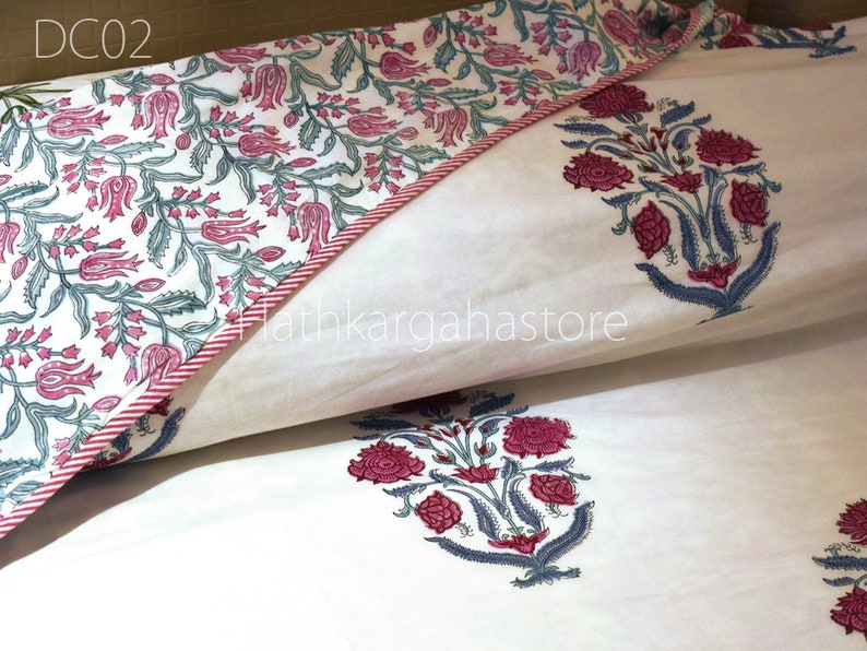 May include: White cotton pillowcase with a pink and green floral print. The pillowcase has a red and white striped border. The text "DC02" is visible in the top left corner of the image.