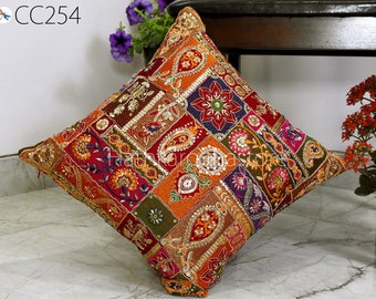 May include: A colorful patchwork cushion cover with intricate embroidery and sequins. The cover features a variety of colors, including red, orange, green, and gold. The cushion cover is made of a soft, durable fabric and is perfect for adding a touch of bohemian style to any room.
