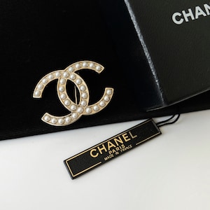 CHANEL, A VINTAGE FAUX PEARL BROOCH designed as a cluste…