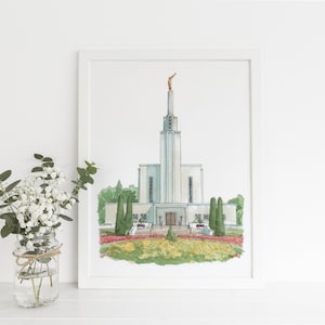 May include: A watercolor painting of a white temple with a tall spire and a golden angel statue on top. The temple is surrounded by green trees and bushes, and there is a red brick walkway leading up to the entrance.