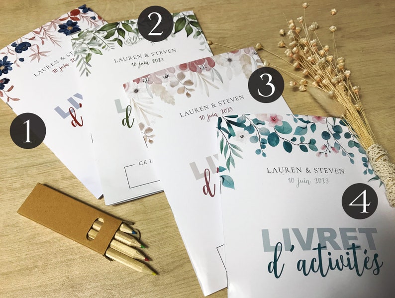 K&ouml;nnte beinhalten: Vier wei&szlig;e Aktivit&auml;tshefte mit der Aufschrift "LIVRET d'activit&eacute;s" und "LAUREN & STEVEN 10 juin 2023" auf der Vorderseite. Jedes Heft zeigt unterschiedliche florale Illustrationen in Blau-, Gr&uuml;n- und Rosat&ouml;nen, erg&auml;nzt durch eine kleine braune Pappschachtel mit Buntstiften.