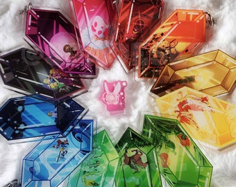 May include: A set of 10 colorful, transparent, acrylic keychains shaped like a crystal. Each keychain features a different character or scene from a video game.
