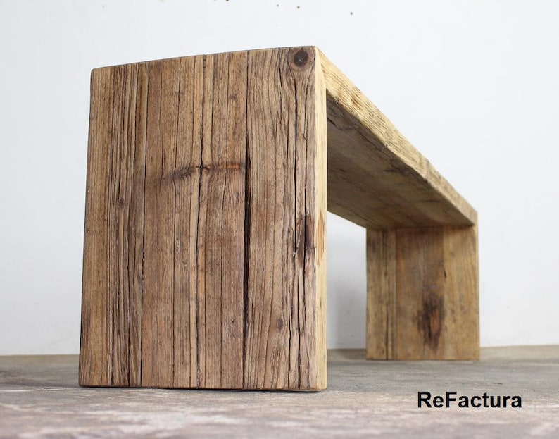Pu&ograve; includere: Panca in legno rettangolare rustica con aspetto naturale e invecchiato. Realizzata con spesse assi di legno, mostra venature e nodi visibili. Design a telaio aperto, adatta per uso interno o esterno. Lunghezza: circa 120 cm.