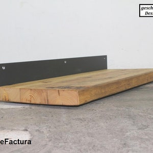 May include: A wooden shelf with a black metal bracket. The shelf is made of natural wood with a rustic finish. The bracket is attached to the wall with screws.