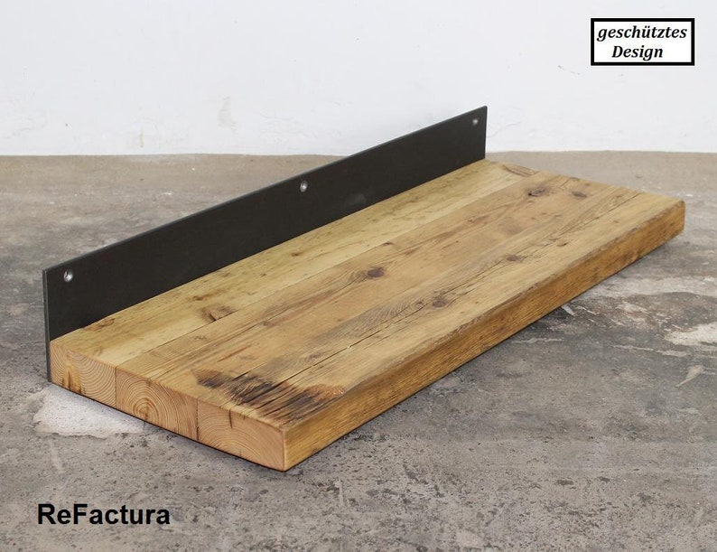 May include: A rustic wooden shelf with a black metal bracket. The shelf is made of reclaimed wood and has a natural finish. The bracket is attached to the underside of the shelf and has a simple design. The shelf is perfect for displaying decorative items or storing small items.
