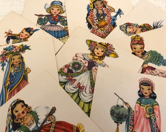 May include: A set of nine vintage illustrations featuring girls in traditional clothing from different cultures. The illustrations are printed on white cardstock and feature vibrant colors and intricate details.