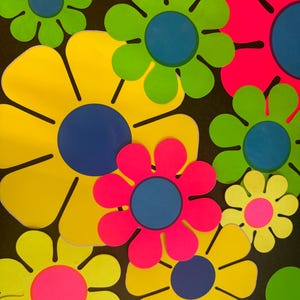 May include: A collection of colorful paper flowers with yellow, green, pink, and blue petals. The flowers have a retro 1960s style.