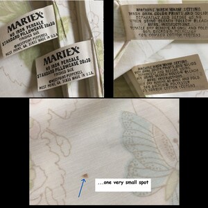 May include: Martex standard pillowcase, 20x30 inches, with a floral and butterfly pattern. The label indicates it's no iron percale and made in the USA. The care instructions are also visible. There is a small brown spot on the fabric.