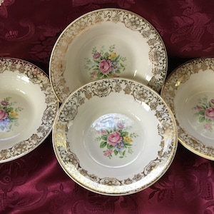 May include: Three white ceramic bowls with gold trim and floral designs. The bowls have a scalloped edge and are perfect for serving soup or salad.